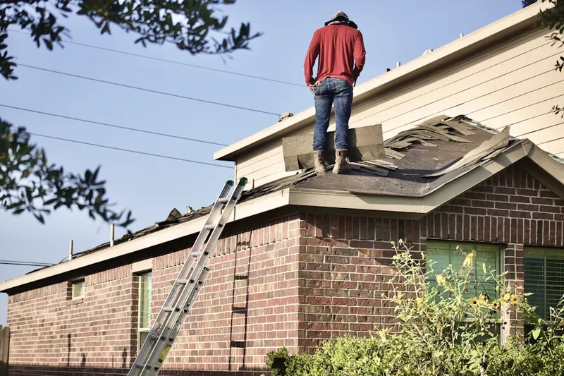 Professional roofer working on a residential roof in Greenbelt